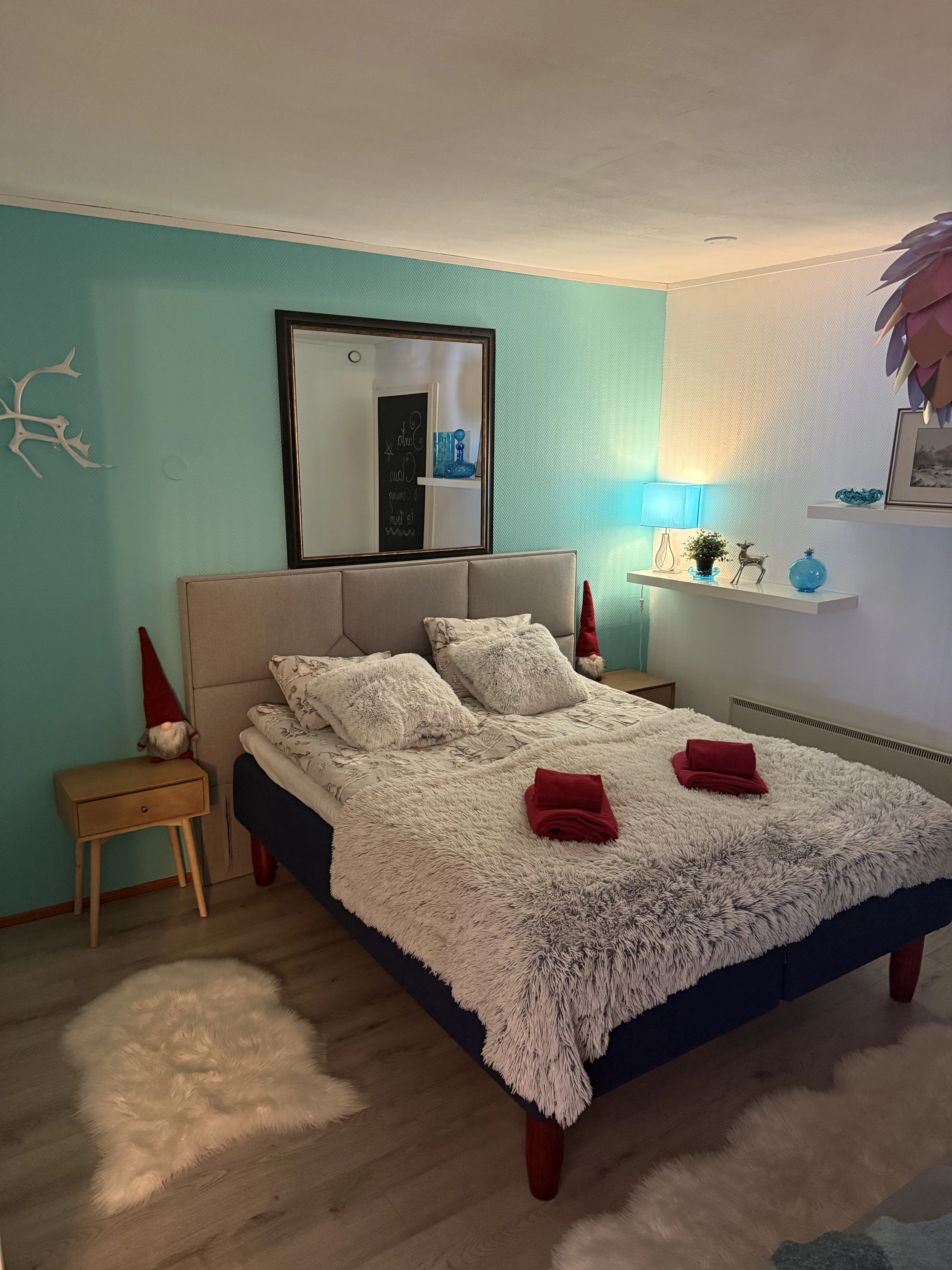 A made-up double bed in one of the villa's bedrooms