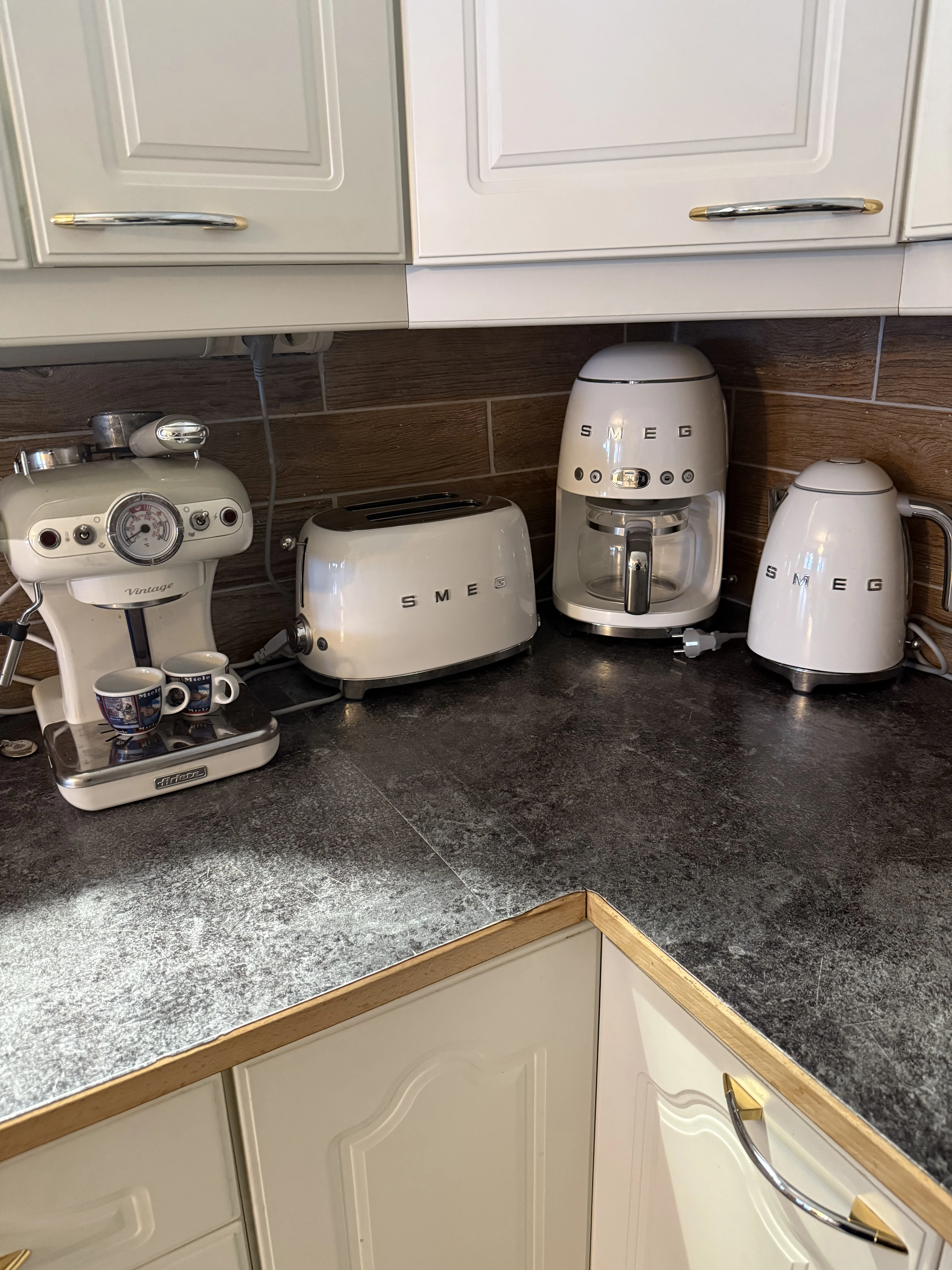 The kitchen counter with a matching espresso machine, toaster and kettle
