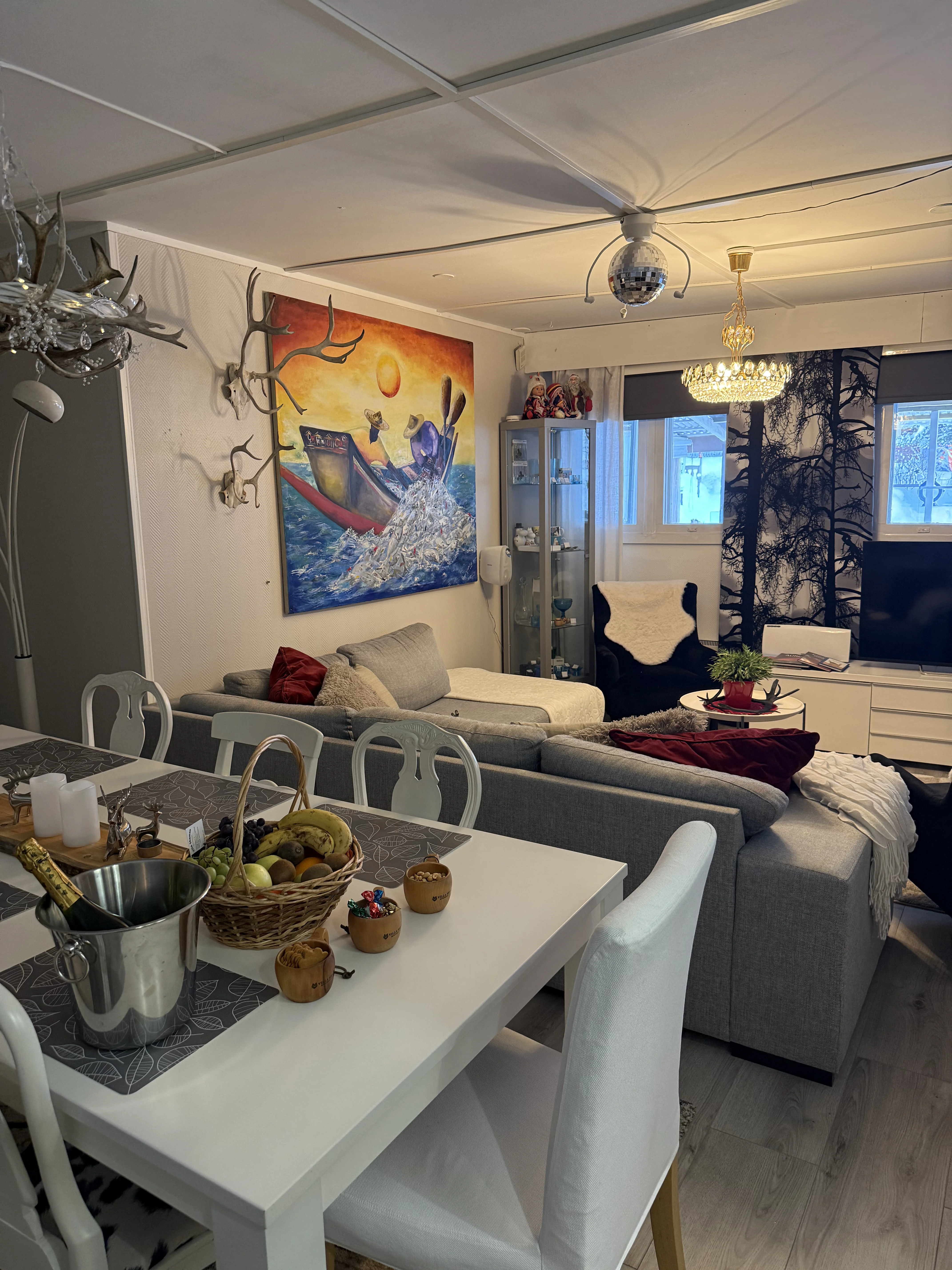 The dining table set for a group, next to the living room