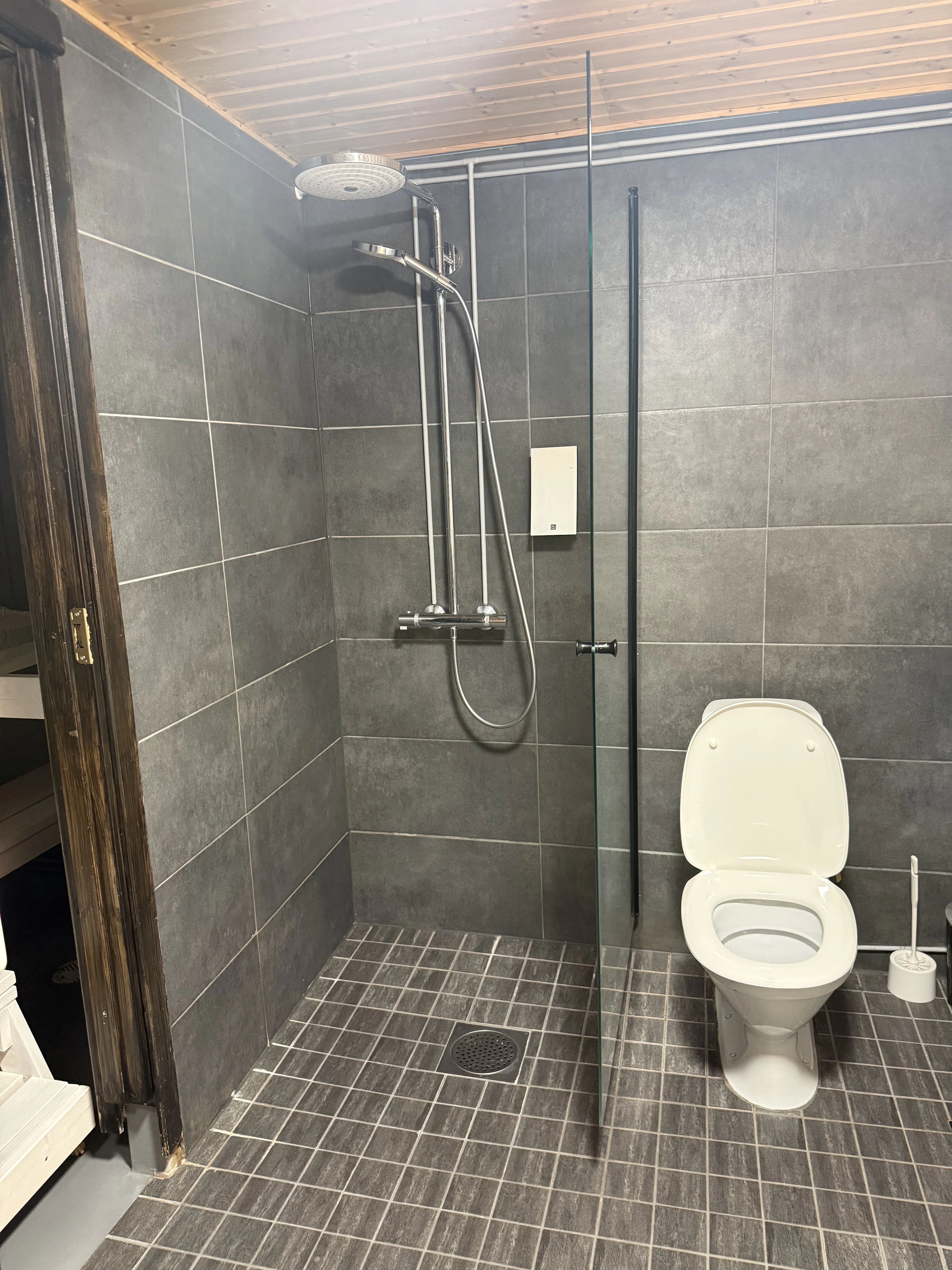 A tiled bathroom with a walk-in shower